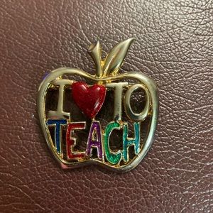 Golden Brooch with “I Love To Teach” on it.